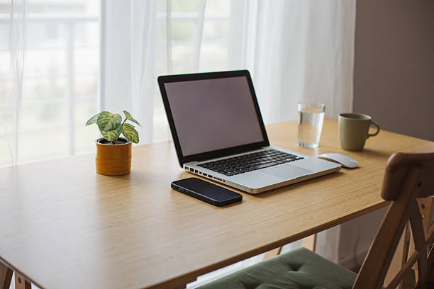 istock Modern home office setup featuring laptop and smartphone on wooden desk 2218325909