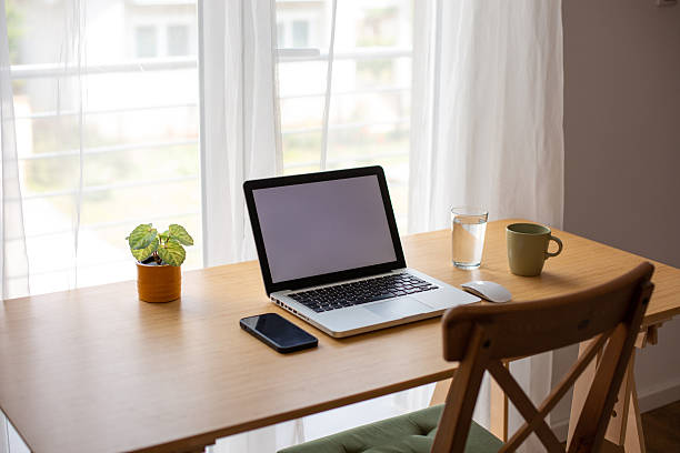 istock Comfortable home office setup with laptop and smartphone on wooden desk 2218325935