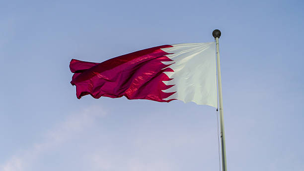 istock qatar flag flying high in the wind. 2218328616
