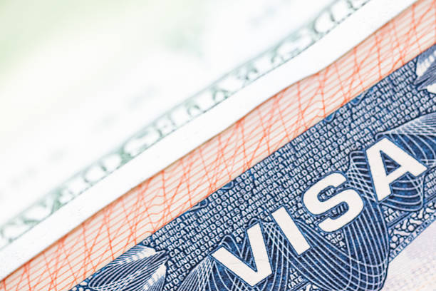 istock US passport visa and paper US dollars. Macro shot. 2218328958