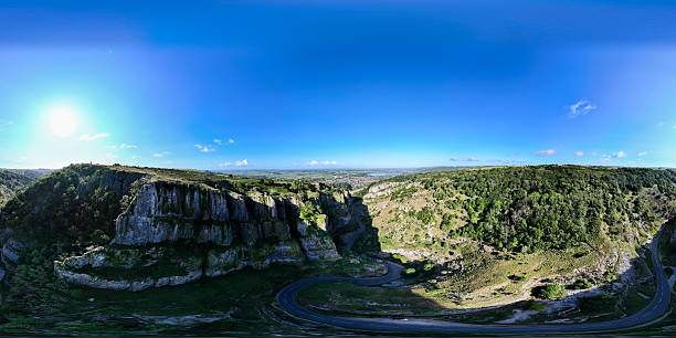 istock Cheddar Gorge illuminating under bright sunlight with winding road and lush greenery 2218331721