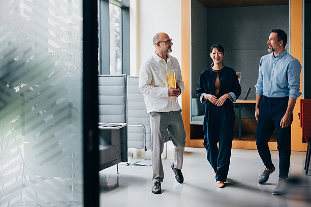 istock Professional Colleagues Walking Together in a Modern Office Setting 2218333088