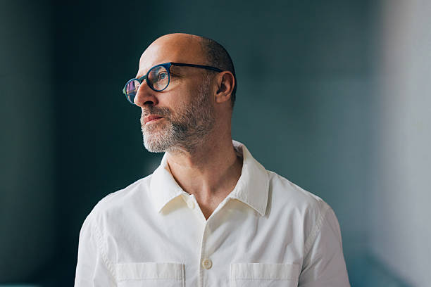 istock Confident Mature Man Wearing Glasses and Staring Thoughtfully 2218333104