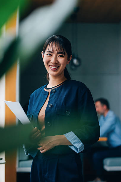 istock Professional Woman Smiling in Creative Workspace with Papers 2218333139