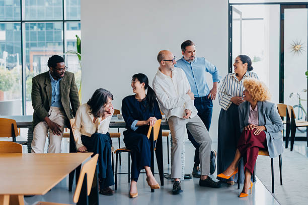 istock Group of Colleagues Smiling and Interacting in a Modern Office Space 2218333170