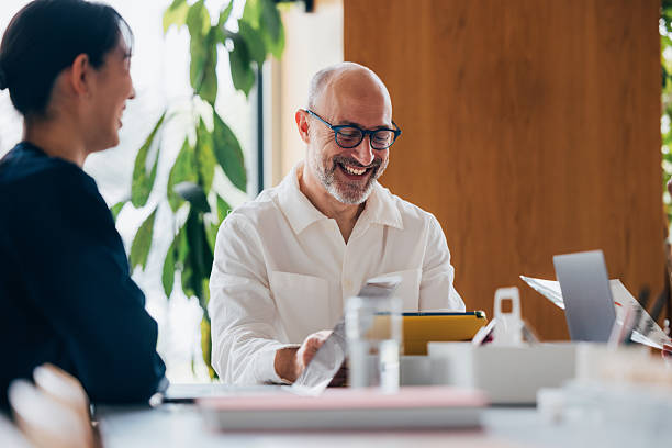 istock Smiling Business Team Collaborating in a Bright and Relaxing Workplace 2218333175