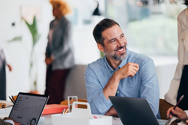 istock Smiling Professional Collaborating in a Modern Office Environment With Colleagues 2218333180