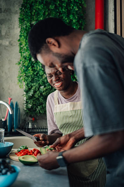 istock Happy couple preparing food and having fun in the kitchen 2218335270