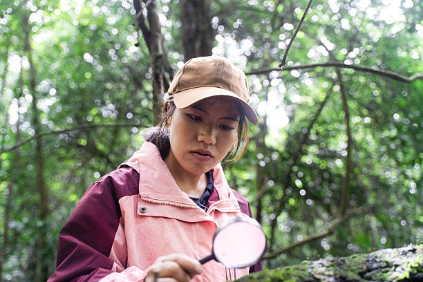 istock A girl exploring outdoors with a magnifying glass 2218338347