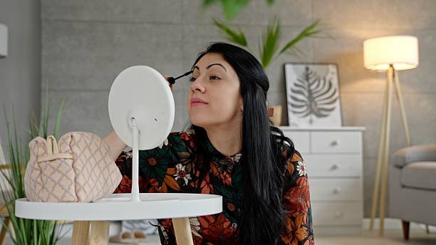 istock Gen Z Woman Applying Makeup In Mirror, Preparing For A Date 2218338853