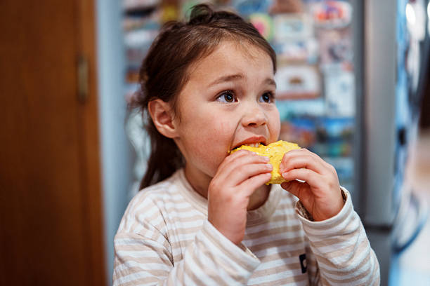 istock Eurasian girl eating mango 2218340973