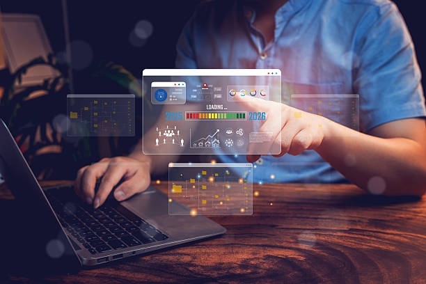 istock Goal 2025 concept. Businessman Using Laptop to Manage Data with Virtual Interfaces and Graphic Charts in a Dark Workspace 2218342532
