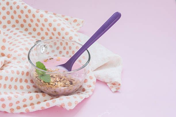 yogurt with granola and mint in a glass cup
