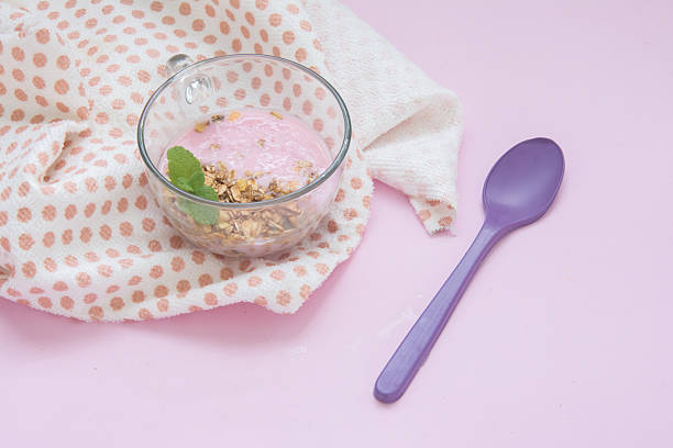 yogurt with granola and mint in a glass cup