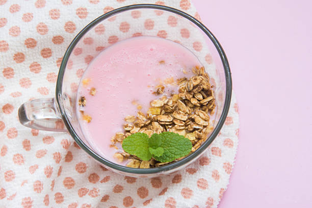 yogurt with granola and mint in a glass cup