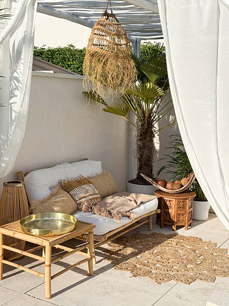 istock Boho bamboo outdoor sofa under driftwood pergola by the swimming pool in warm sunlight 2218347663