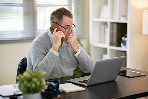 istock A businessman is sitting at his desk working. 2218350726