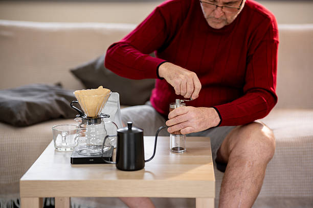 istock An elderly man is happily making coffee on a bright morning at his home. 2218351086