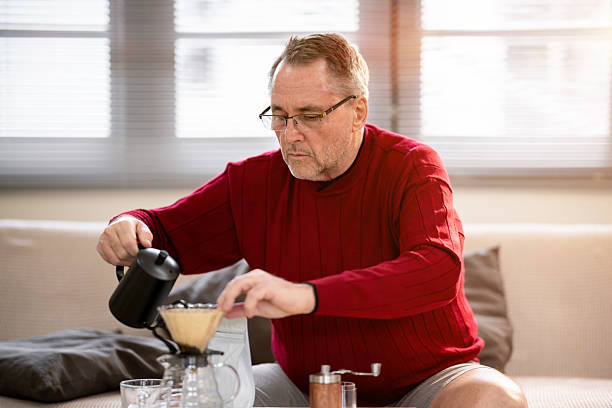 istock An elderly man is happily making coffee on a bright morning at his home. 2218351097