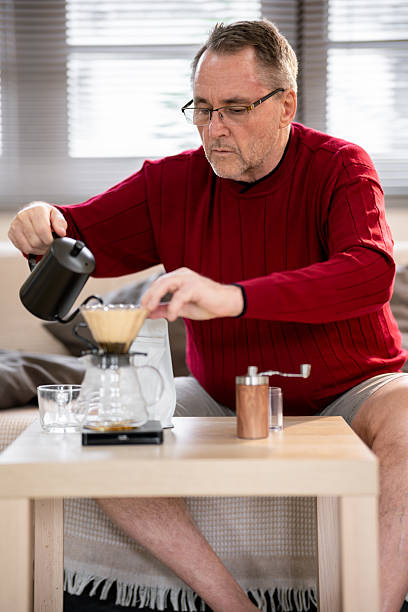 istock An elderly man is happily making coffee on a bright morning at his home. 2218351099