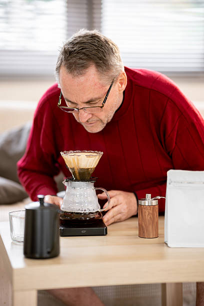 istock An elderly man is happily making coffee on a bright morning at his home. 2218351108