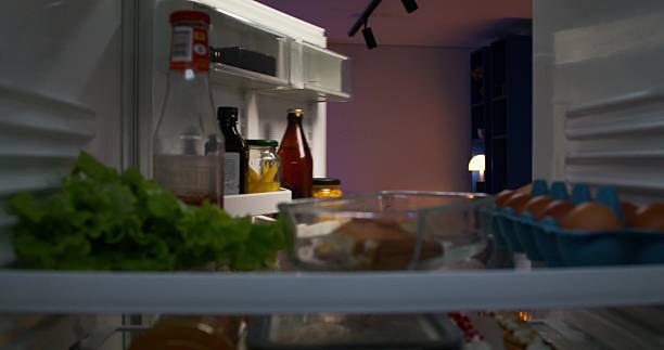 istock A man takes a bottle of beer from the fridge 2218355128