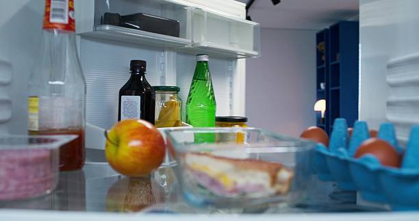 istock A man takes a bottle of water from the refrigerator 2218355171
