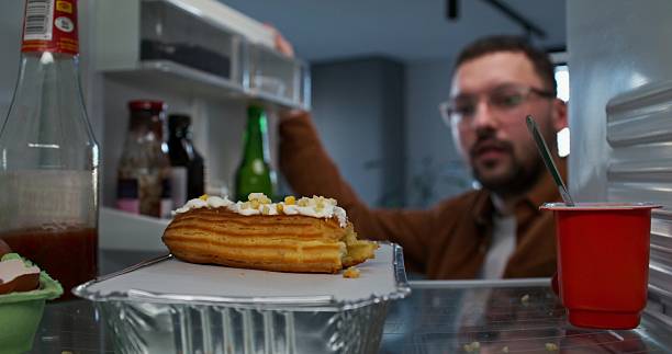 istock A man takes food from the fridge 2218355252