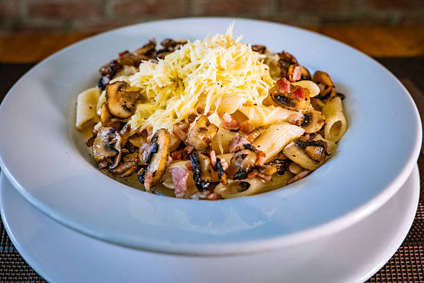 Short pasta with carbonara sauce and mushrooms