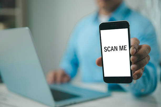 istock Businessman using smartphone with SCAN ME screen Cashless technology concept Scanning QR code with mobile smartphone Electronic wallet QR code payment 2218359926