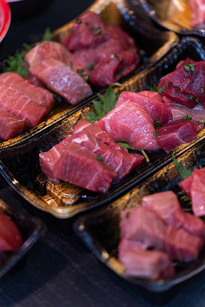Assorted Cuts of Fresh Tuna Sashimi in Black Trays