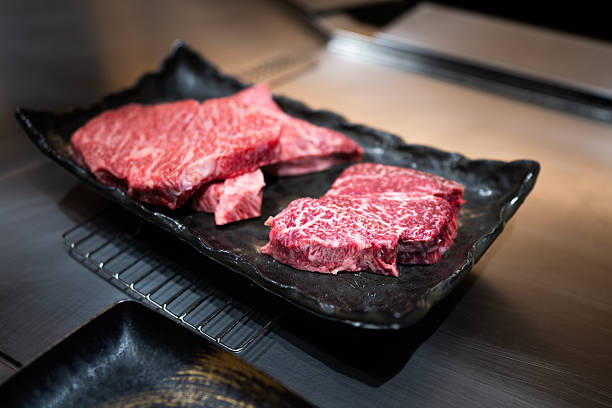 istock Premium Cuts of Raw Wagyu Beef on Ceramic Tray 2218360677