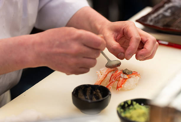 istock Crab Nigiri Being Garnished by Chef with Spoon 2218360902