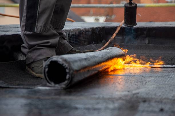 istock Roofer during waterproofing work with bitumen membranes 2218368490