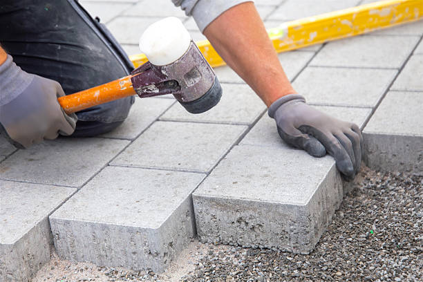 istock Craftsmen lay paving stones in the garden 2218368504