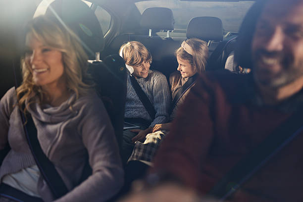 istock Happy siblings talking while going on a trip with their parents by car. 2218371851