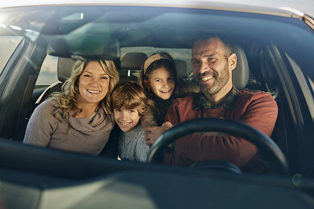 istock Happy family enjoying while going on a road trip by car. 2218372797