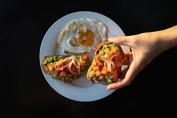 Avocado Toast with Fried Egg on White Plate