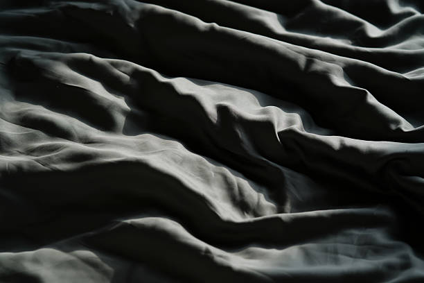 istock Abstract background with dark green cotton sateen bed linen. 2218374971
