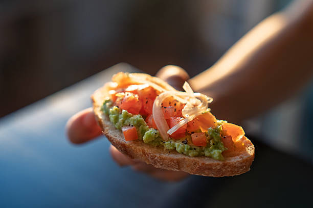 Avocado Toast Topped with Fresh Tomatoes and Onions