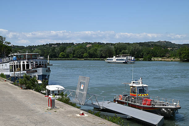 Avignon, France, may 23, 2025 : Tourist transport boats on the Rhone on a sunny day
