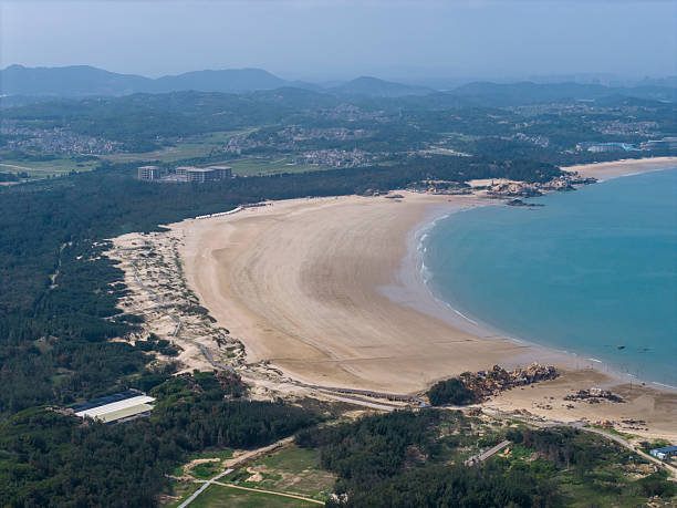 istock Aerial View of a Sandy Beach with Lush Greenery 2218388404