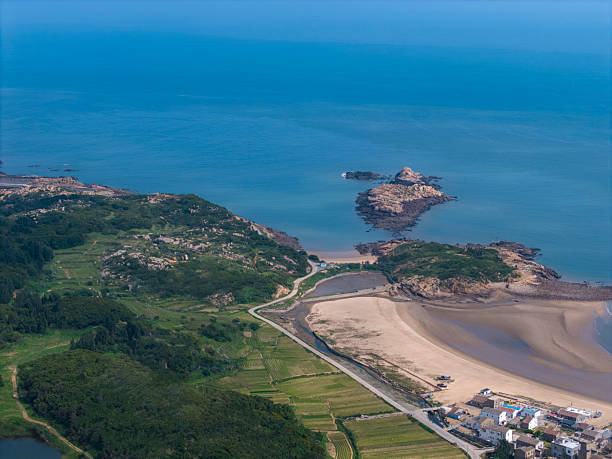 Coastal View with Boats and Rocky Shoreline