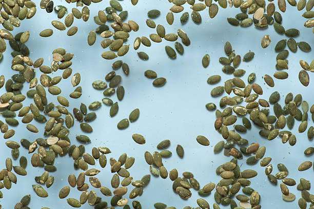 An artistic display of green seeds scattered on a soft background, emphasizing their unique shapes and colors while promoting a healthy and visually appealing kitchen environment.
