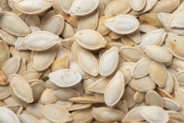 istock Close-Up of Raw White Pumpkin Seeds on Natural Surface 2218389144