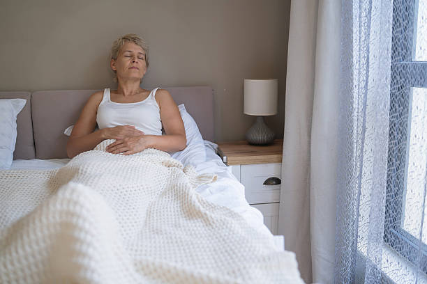 istock Relaxed woman resting on her bed with a calm expression 2218391489