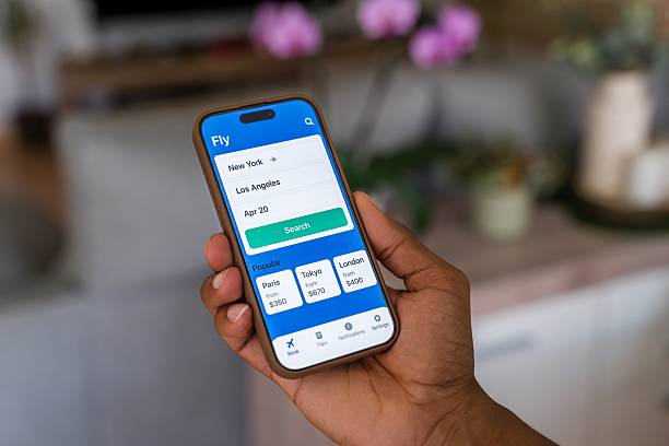 istock Person holding smartphone displaying flight booking app 2218391548