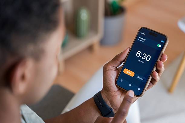 istock Man waking up and stopping alarm on smartphone 2218393224