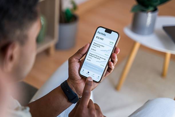 istock Investor checking his stock portfolio on smartphone app 2218393583