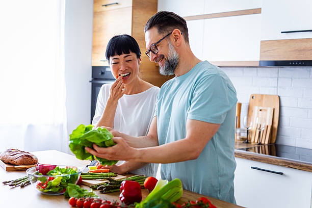 Happy Partners Preparing Salad in Modern Kitchen
